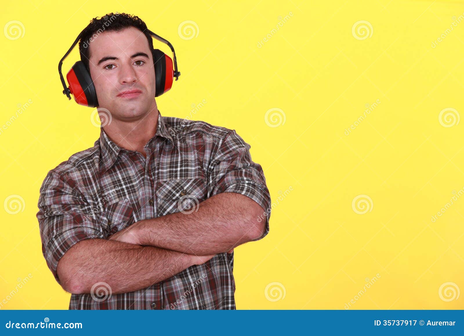 Handyman wearing ear muffs stock image. Image of builder 35737917