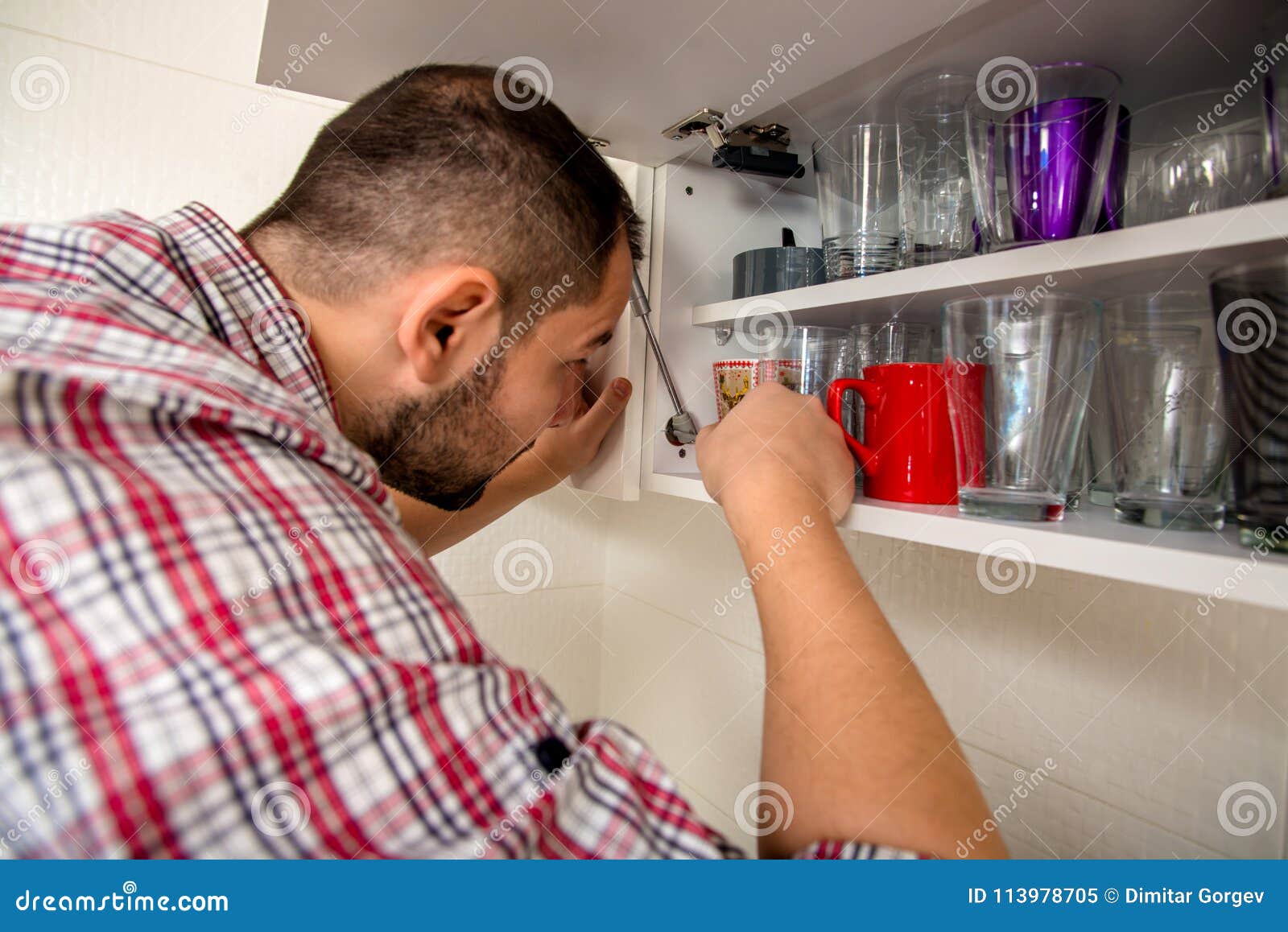 Handyman Repair Door on the Cabinet in the Kitchen Stock Image - Image