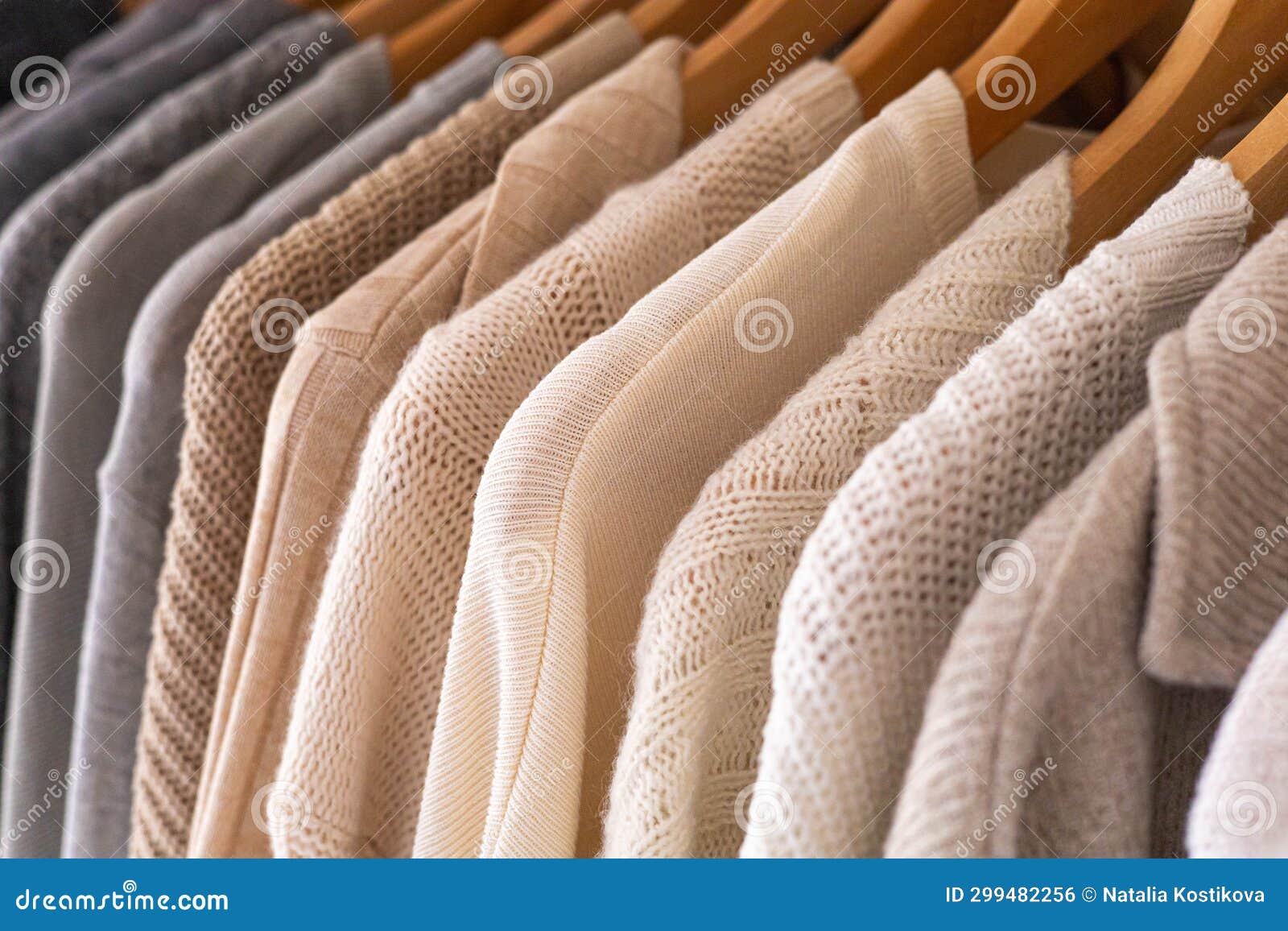 Hanger with Neutral Beige and White Clothes on a White Background