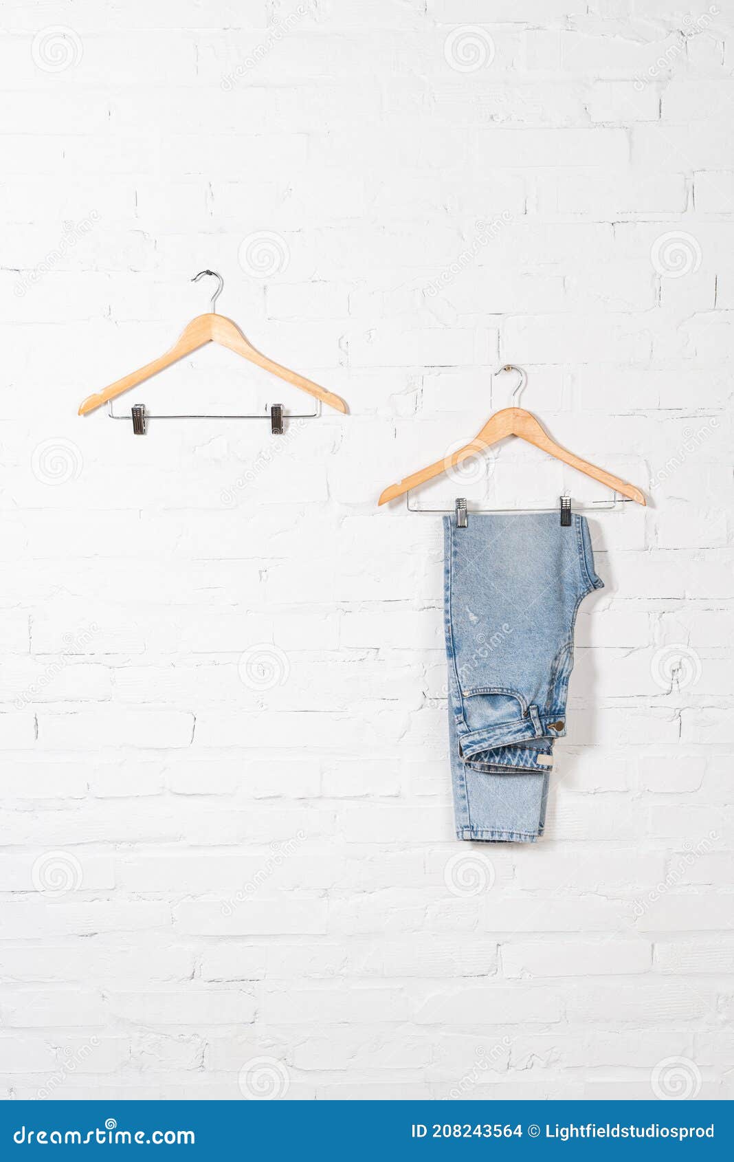Hangers and Blue Jeans Near White Brick Wall. Stock Photo - Image of ...