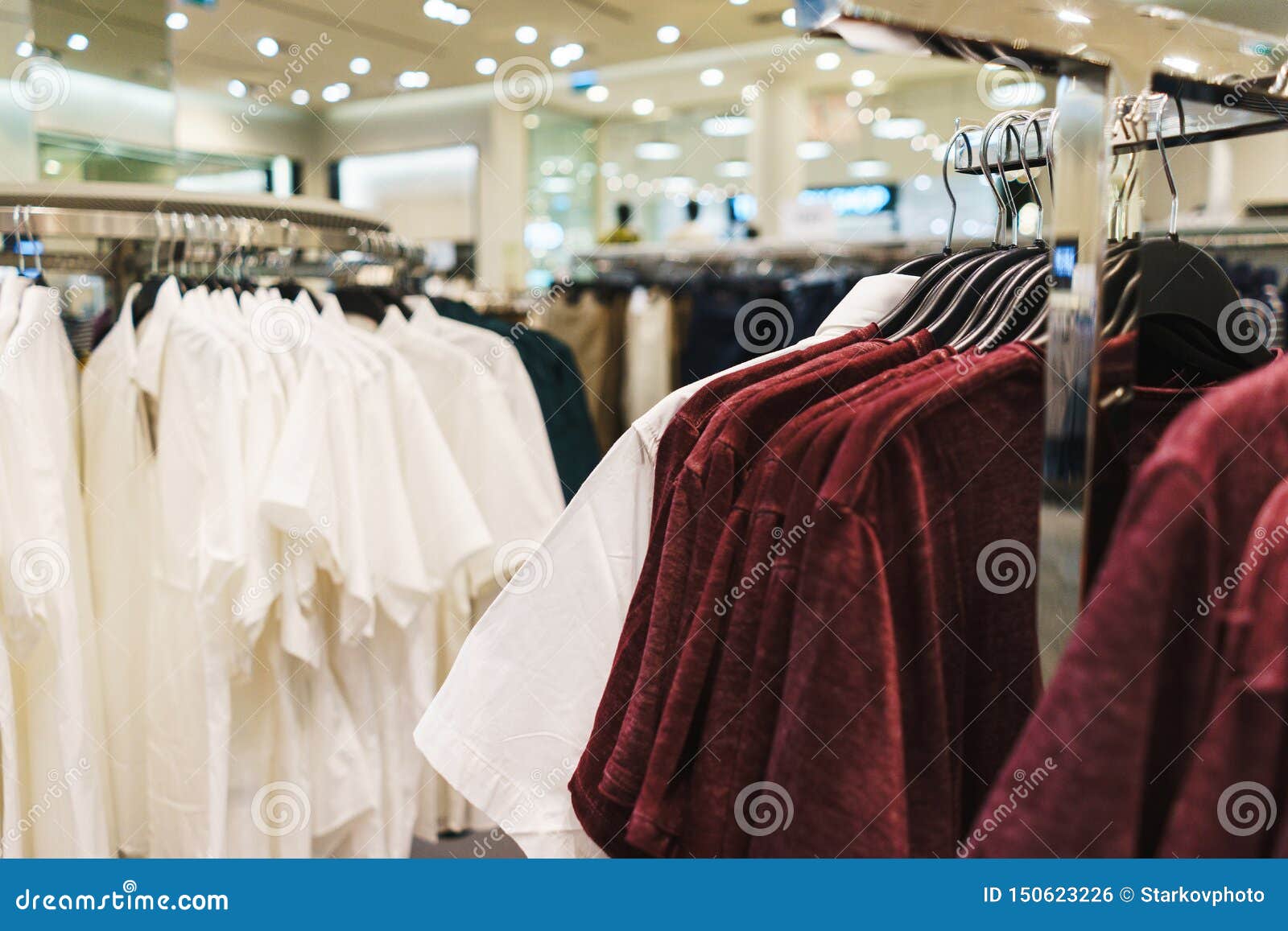 Hangers Bright Fashionable Clothes. T-shirts, Blouses and Shirts on a ...