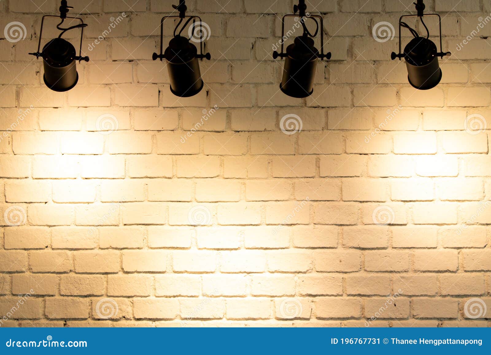 Hanging Spotlight Illuminate At Brick Wall Background Stock Photo