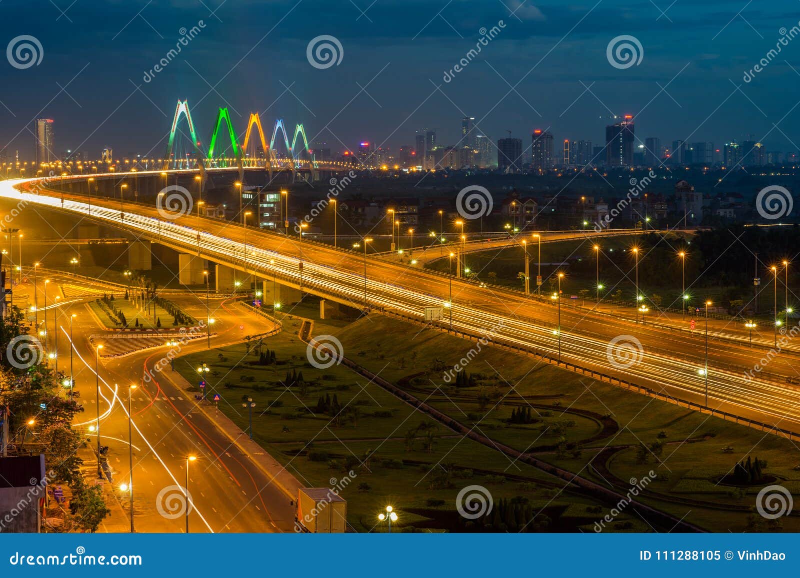 hanoi skyline at twilight at vo chi cong street, leading to nhat tan cable-stayed bridge, anh district