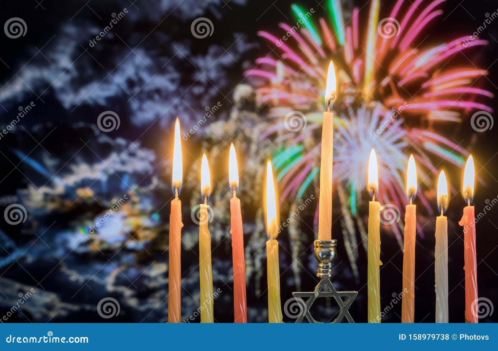 hanukkah menorah with candles, colorful firework sky background