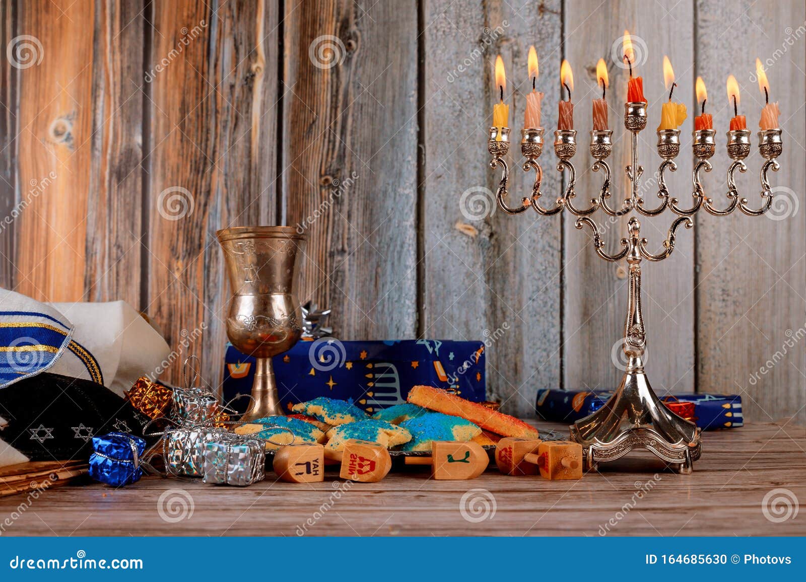 jewish holiday hanukkah with menorah traditional candelabra and wooden dreidels spinning