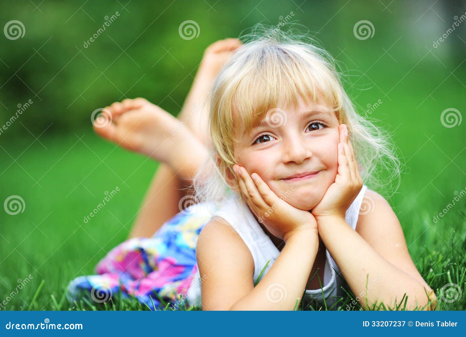 Happiness girl. Little girl relaxing on green grass