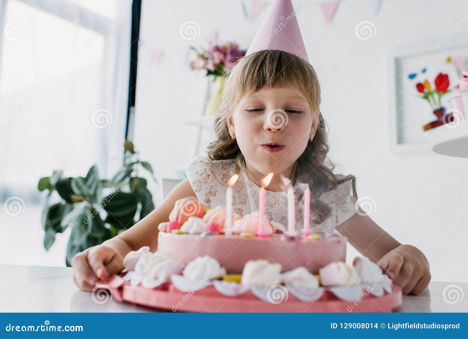 Happy Adorable Kid in Cone Blowing Out Candles from Birthday Stock ...
