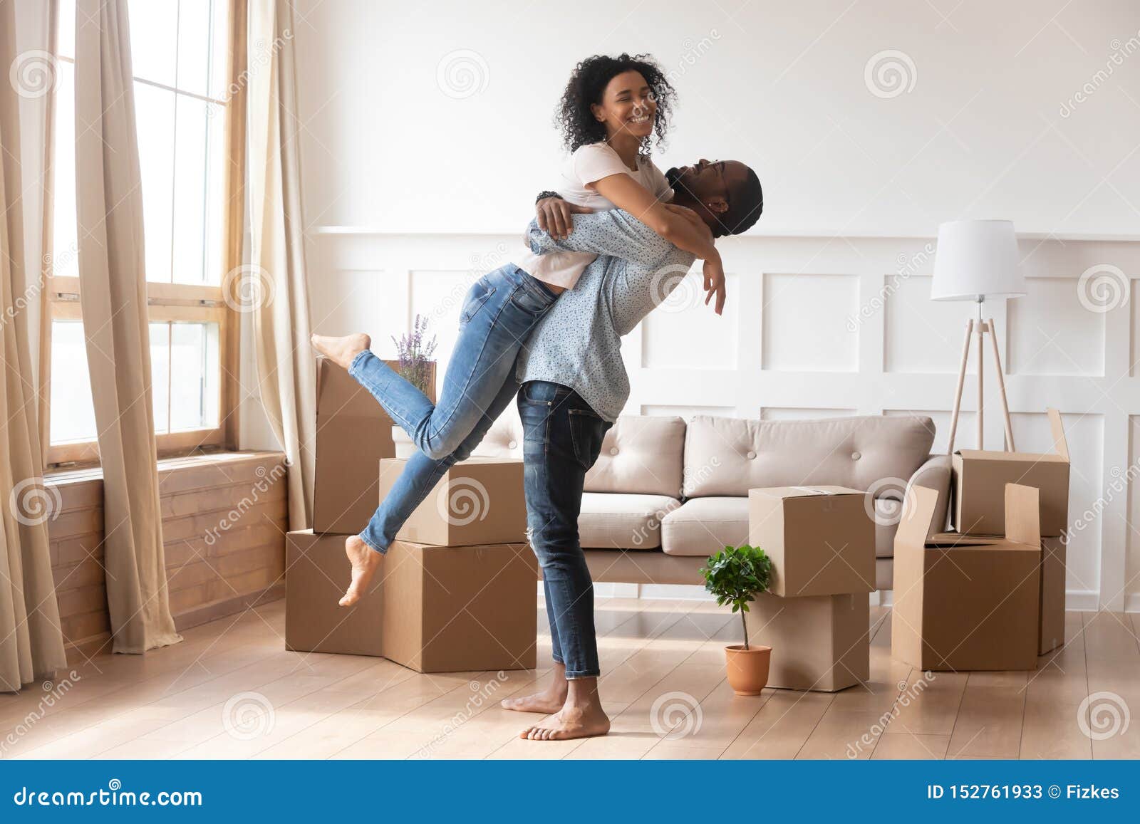 happy african couple first time home buyers celebrate moving day