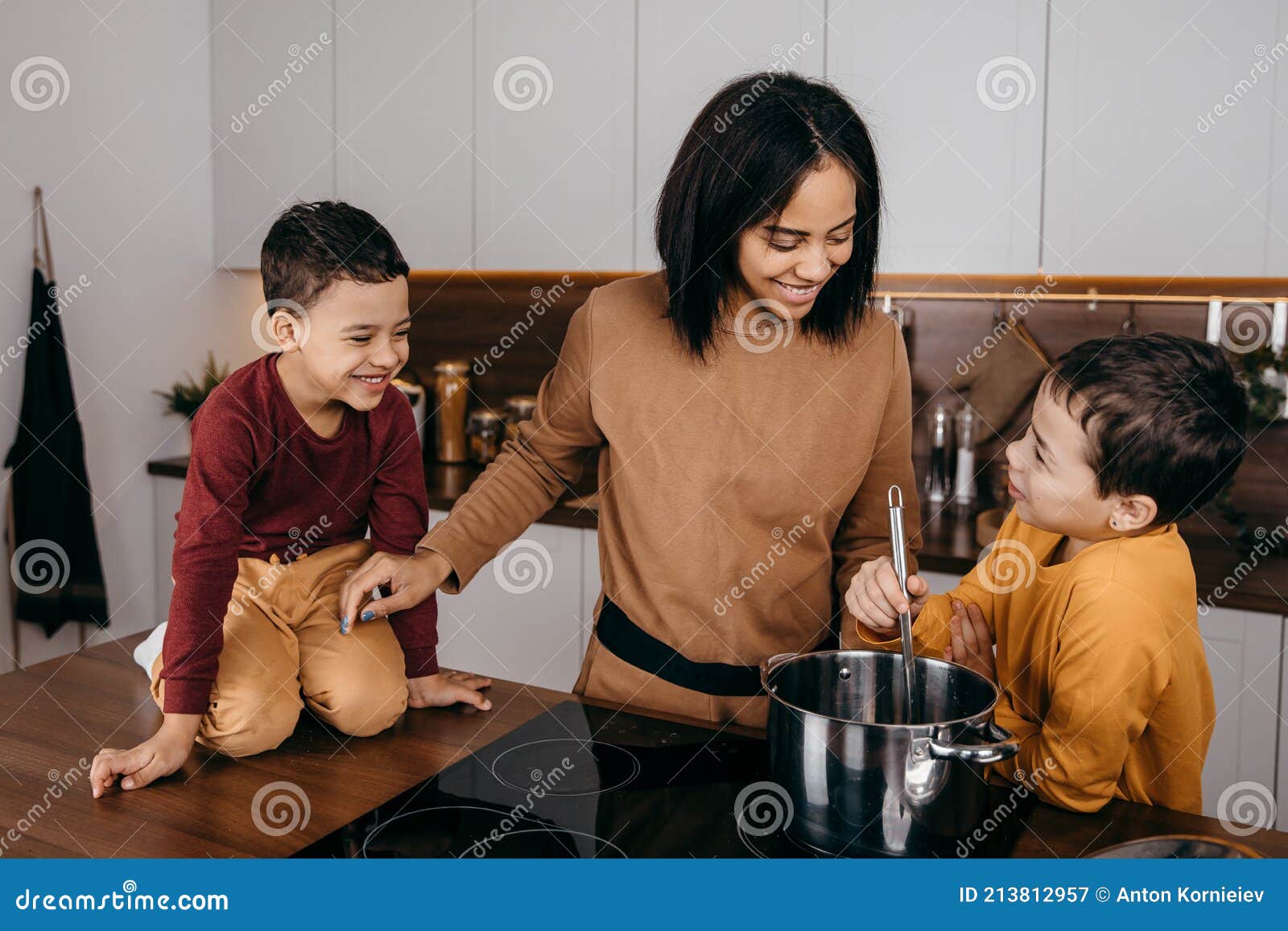 Happy African American Family Mom And Two Sons Having Fun Cooking Lu