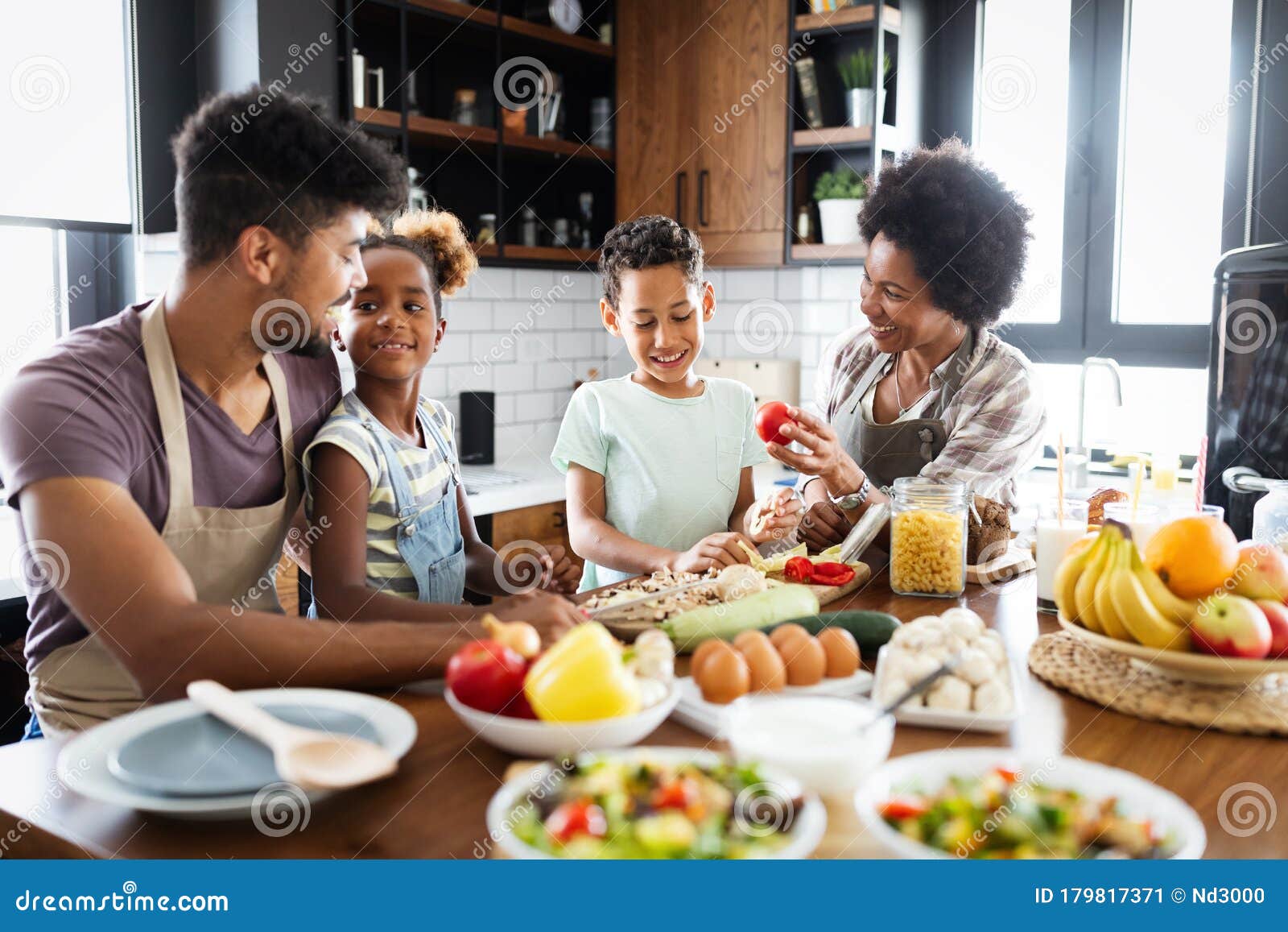 Happy African American Family Preparing Healthy Food Together in
