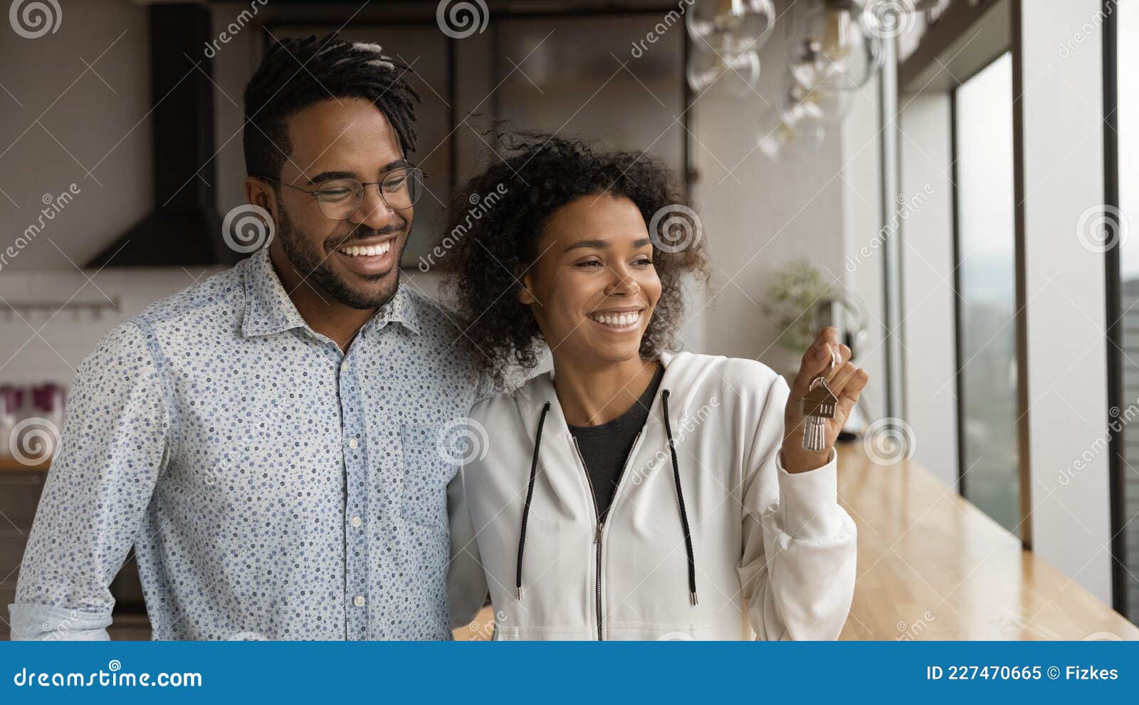 happy african couple holding bunch keys new house pose kitchen smile look aside wife bought luxury young family 227470665