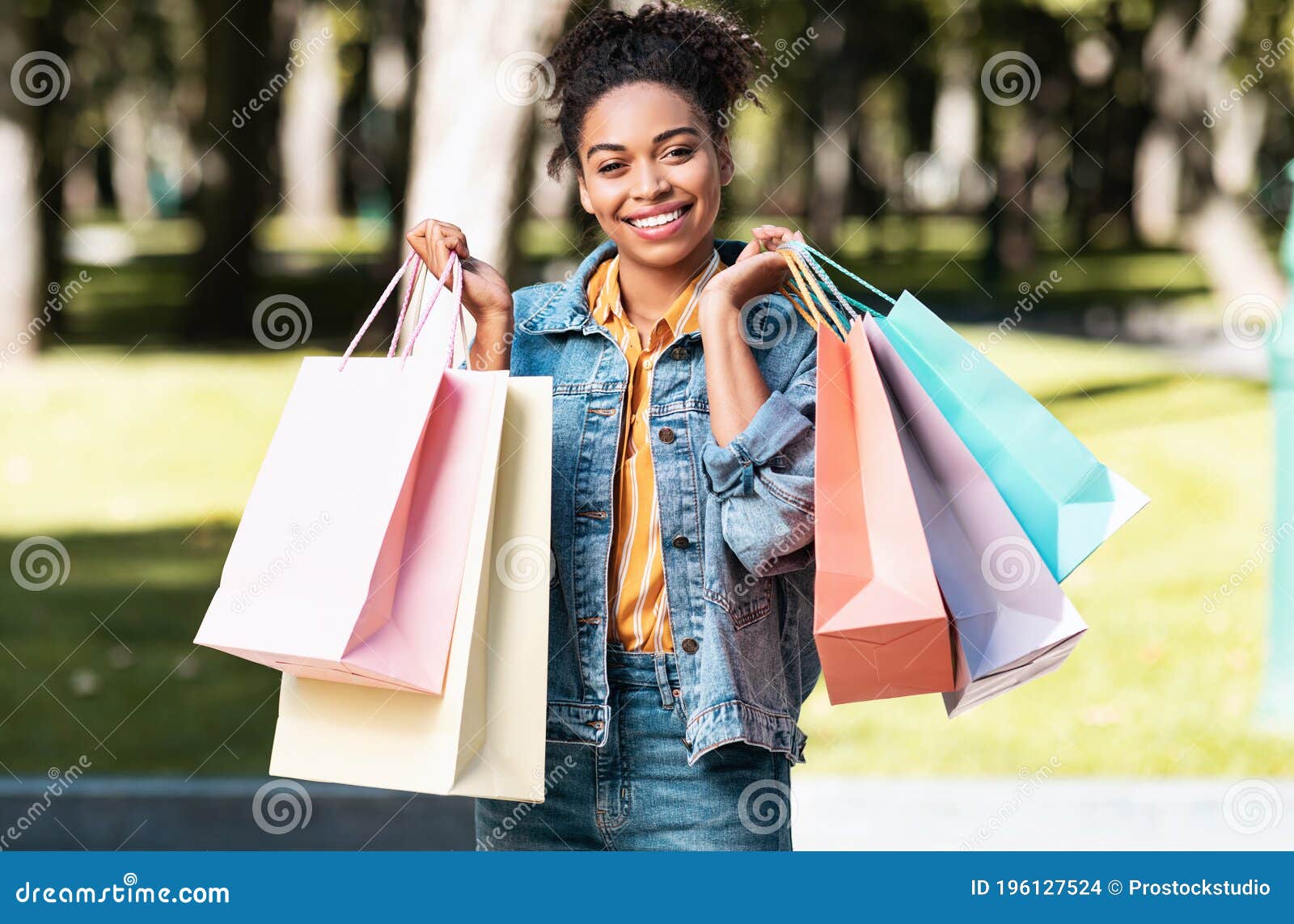 Happy African Girl Holding Colorful Shopper Bags Standing Outdoor Stock ...
