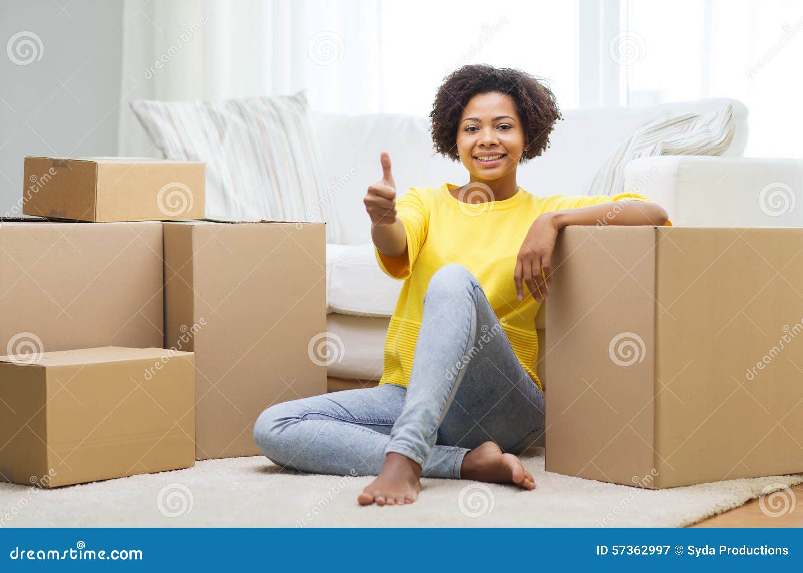 happy african woman with cardboard boxes at home