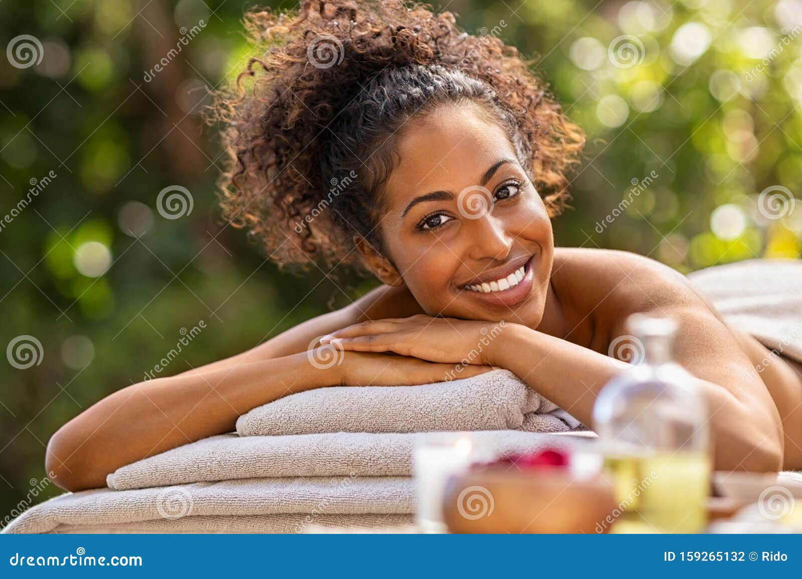 happy african woman in resort spa