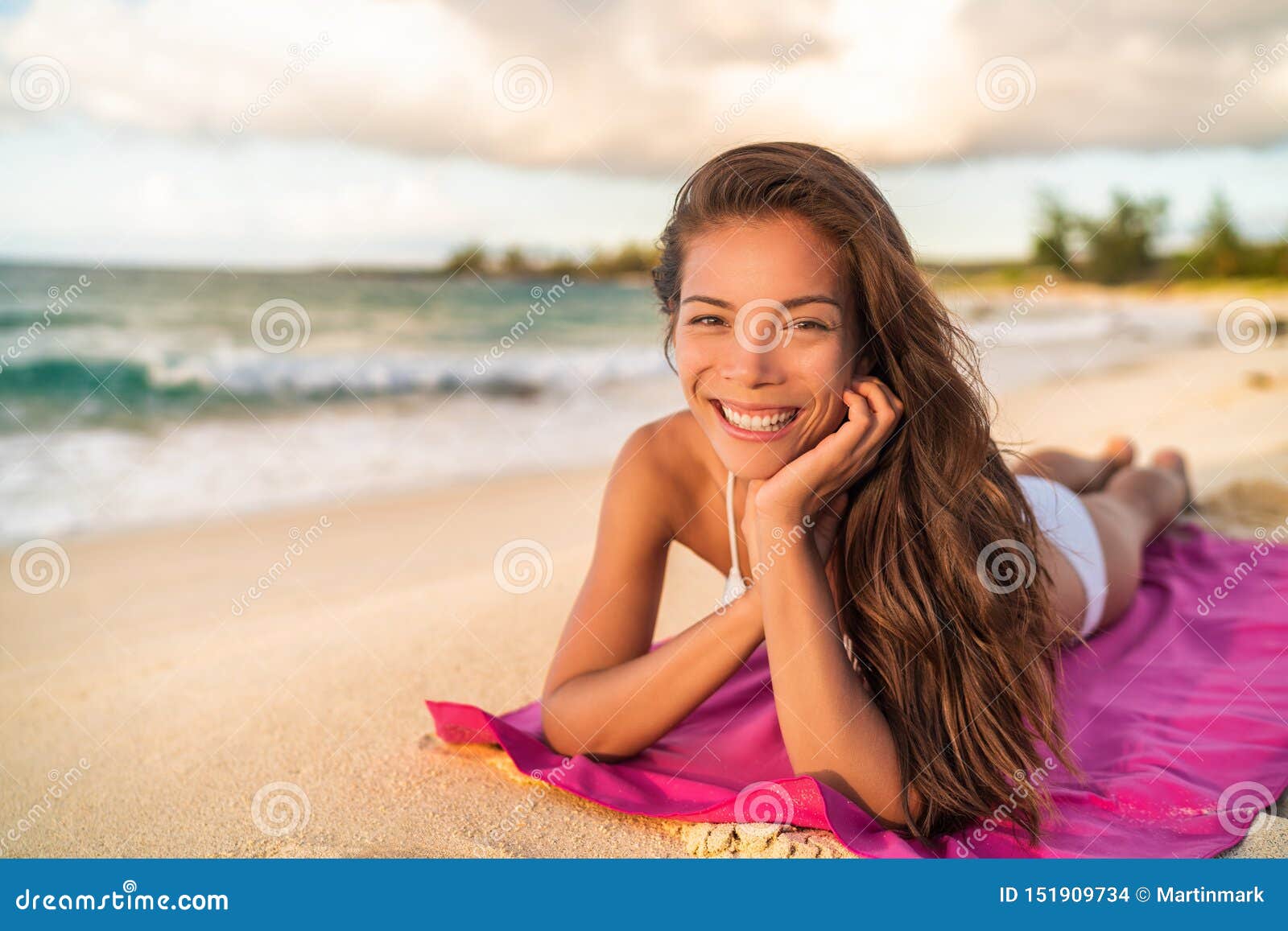 Happy Asian Bikini Wwoman Model Relaxing on Summer Vacation Lying on Beach Towel, Hawaii Stock Photo
