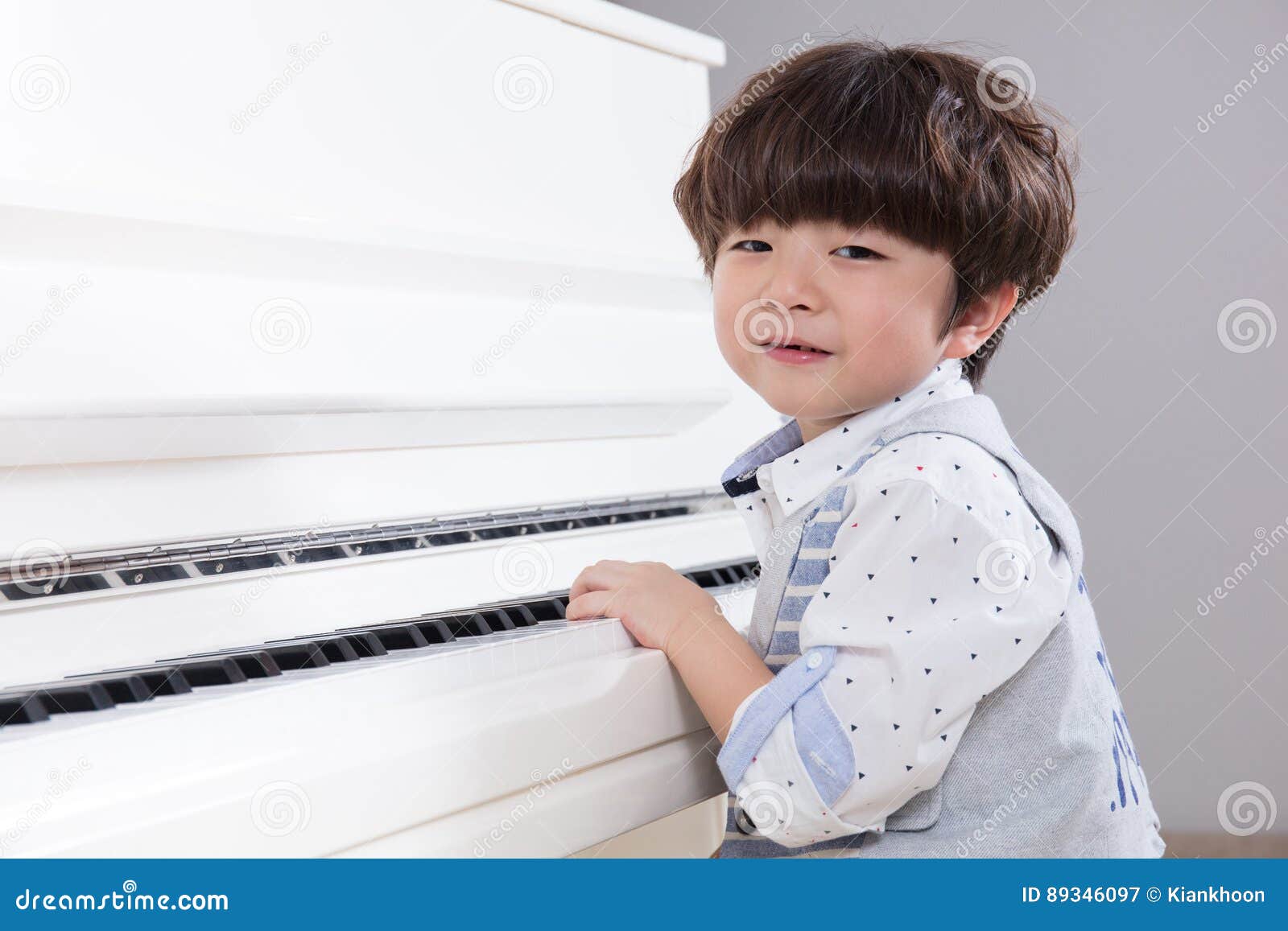 Happy Asian Chinese Little Boy Playing Piano at Home Stock Image