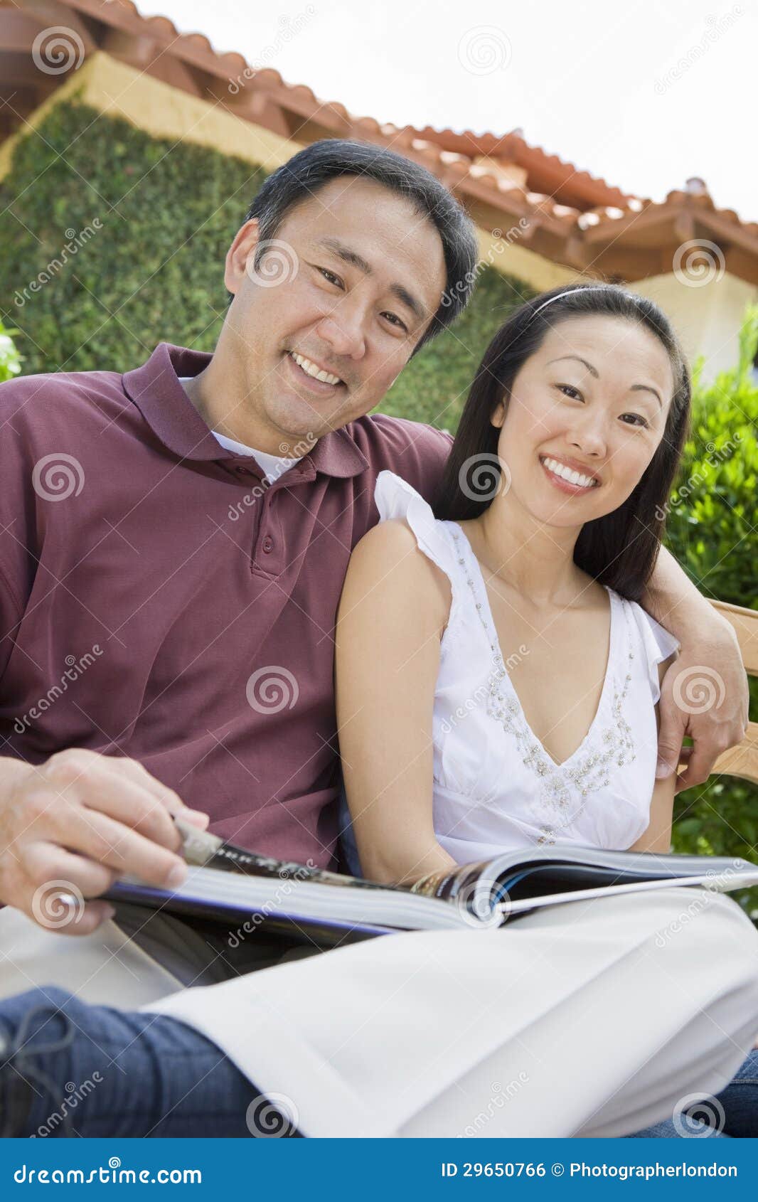 happy asian couple with novel