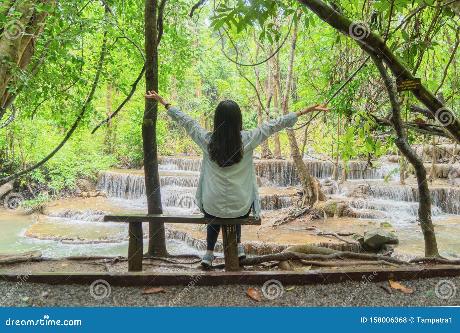 Happy Asian Woman Relaxing and Enjoying at Waterfall with Trees in the ...