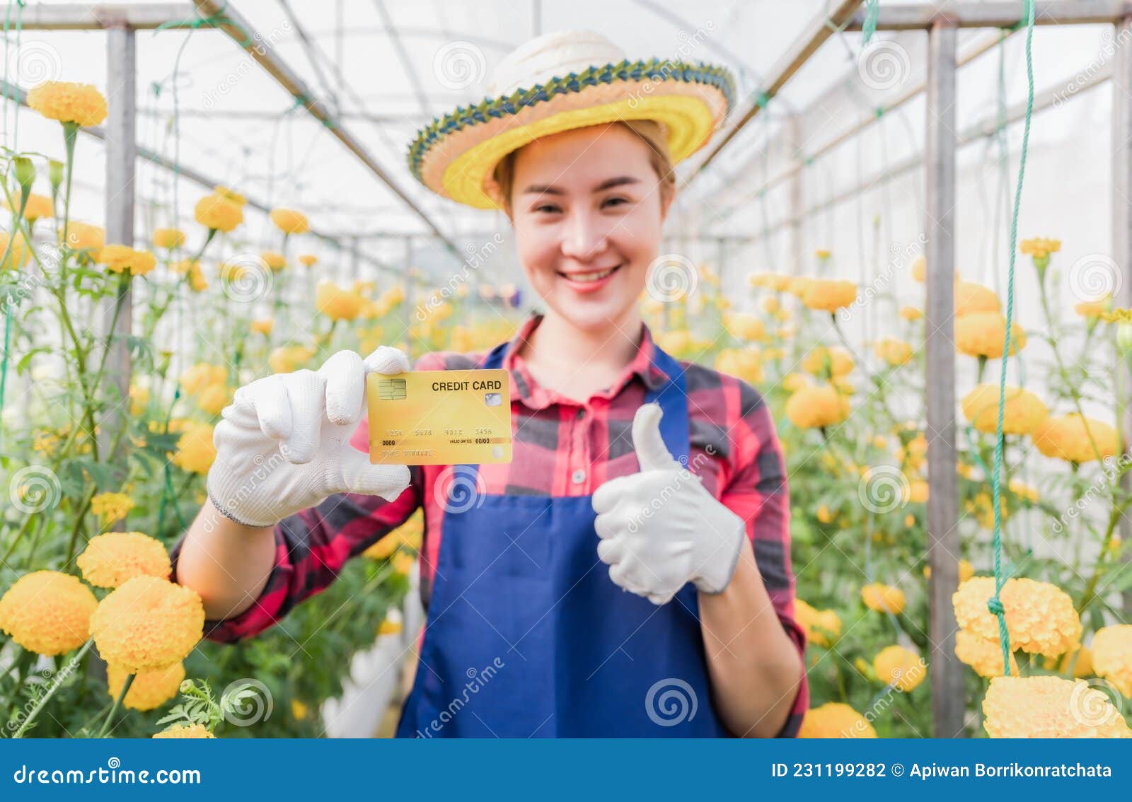 happy asian woman standing and holding credit card