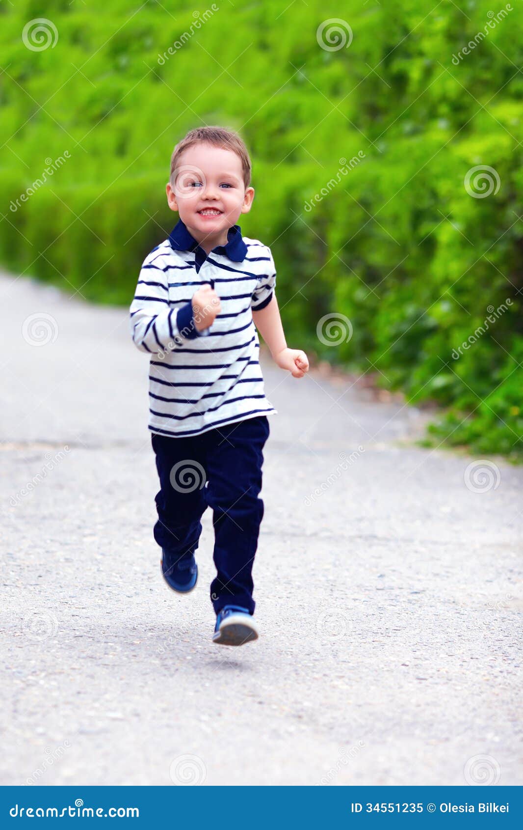 happy baby boy running spring street motion 34551235