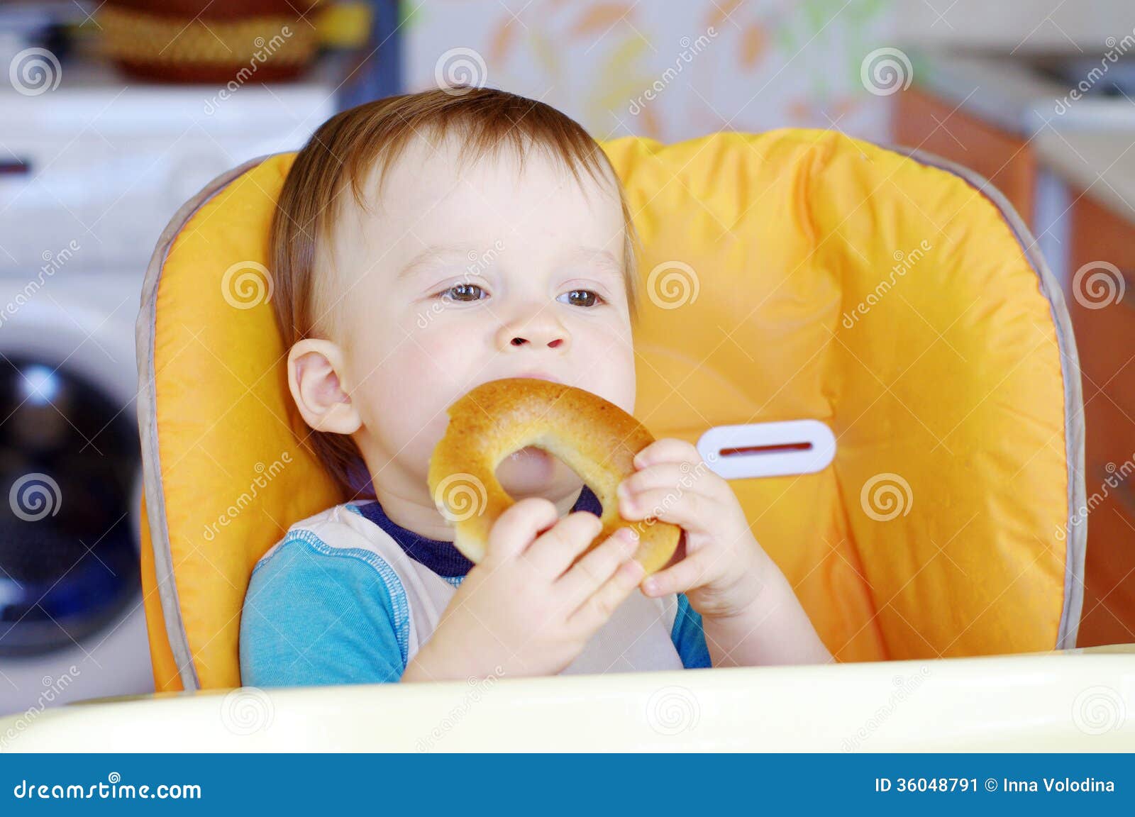 happy baby eating round cracknel