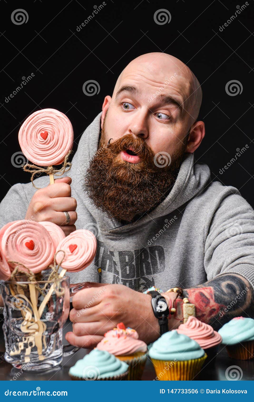 Happy Bearded Bald Man Holding Two Cream Cakes on Black Background