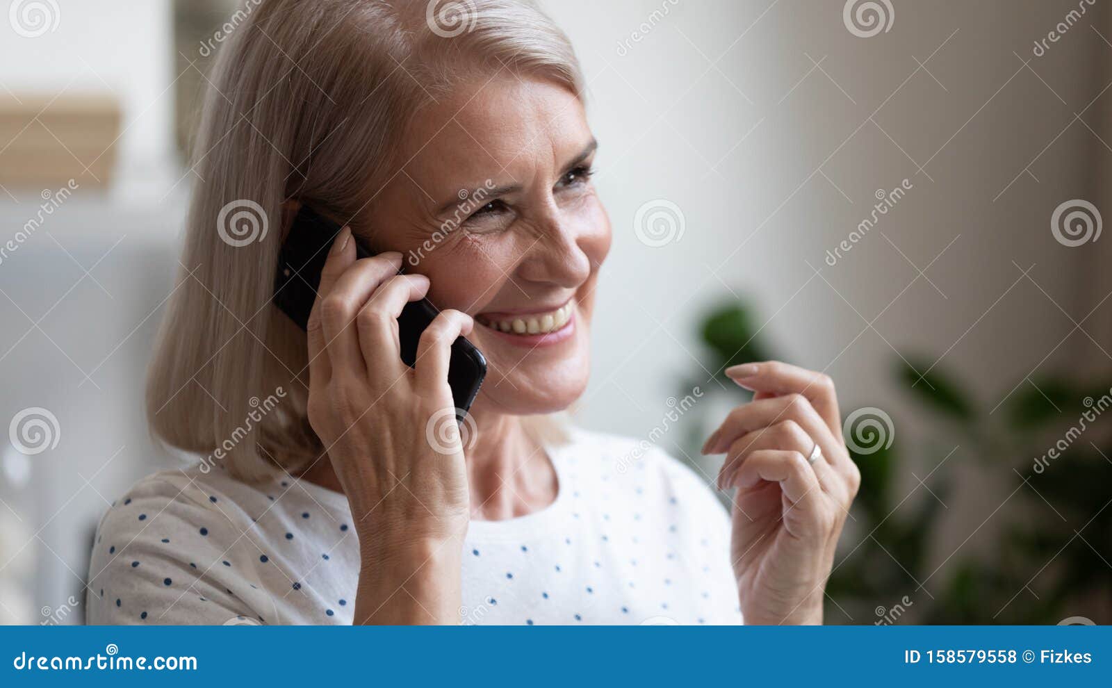 happy beautiful mature woman making phone call close up