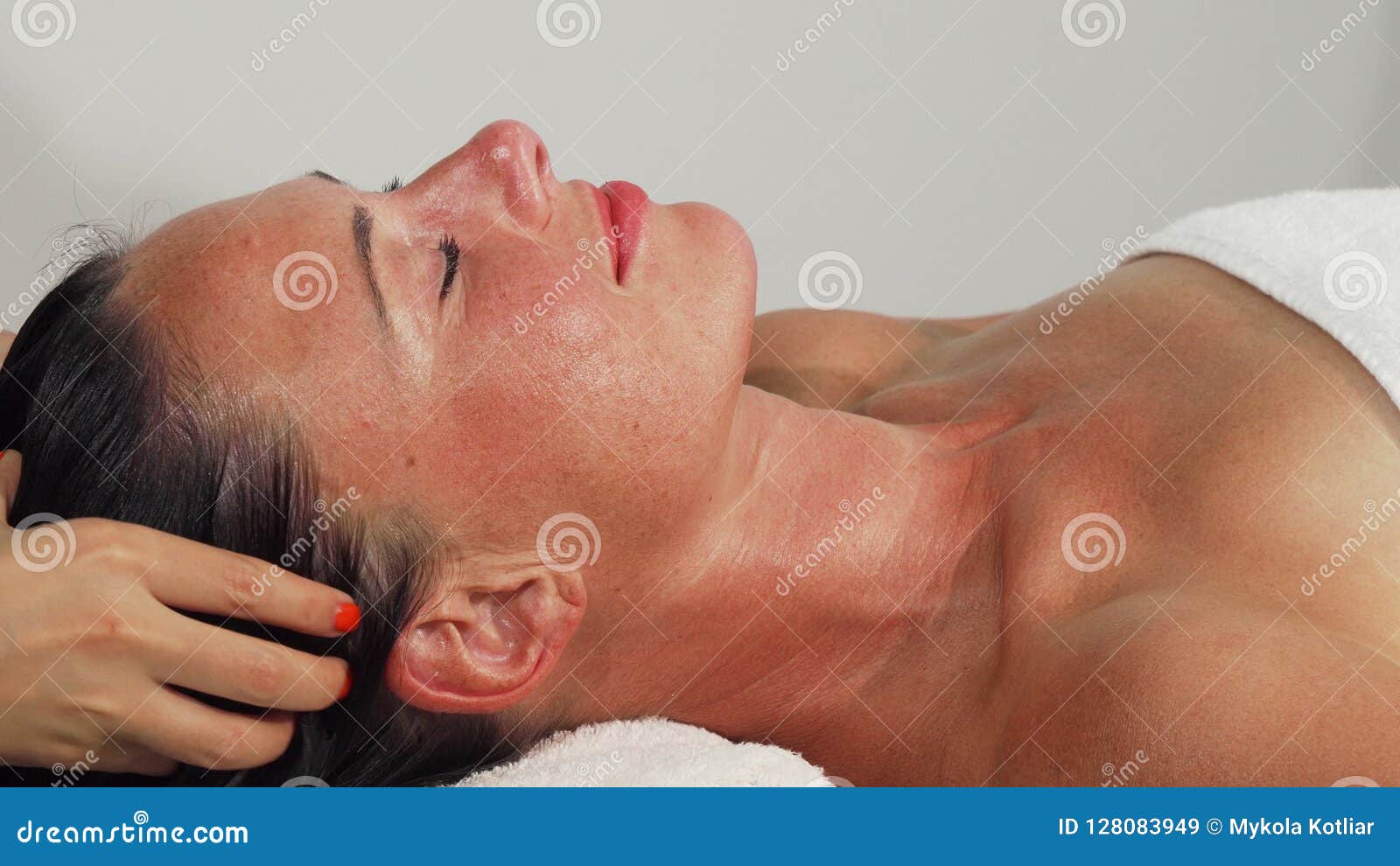 Happy Beautiful Mature Woman Smiling While Getting Head Massage Stock