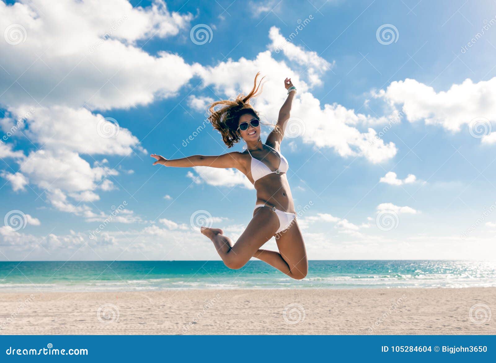 Happy Bikini Asian Woman Jumping of Joy on Beach