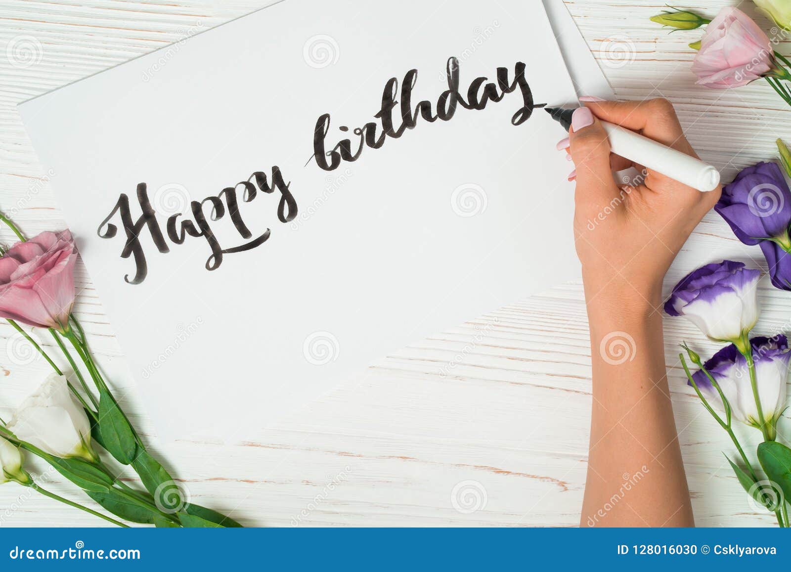 happy birthday congratulations. calligrapher writes with black ink on white card. calligraphy. ornament font. the art of