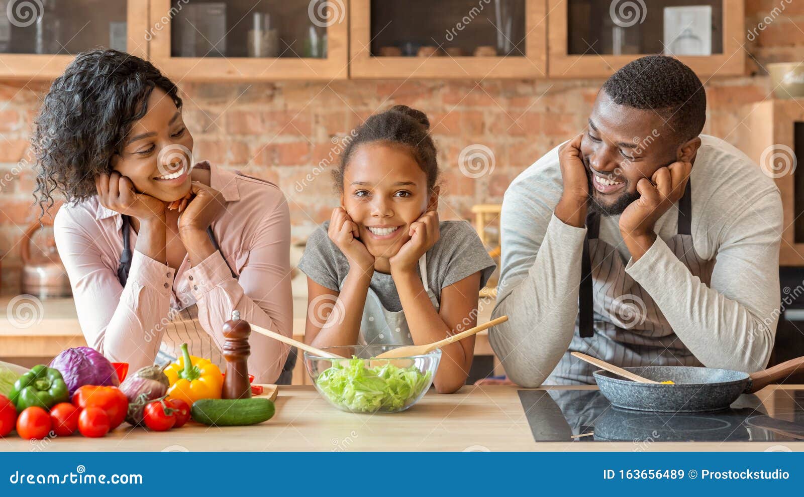 Happy Black Family Cooking Healthy Dinner Together at Kitchen Stock
