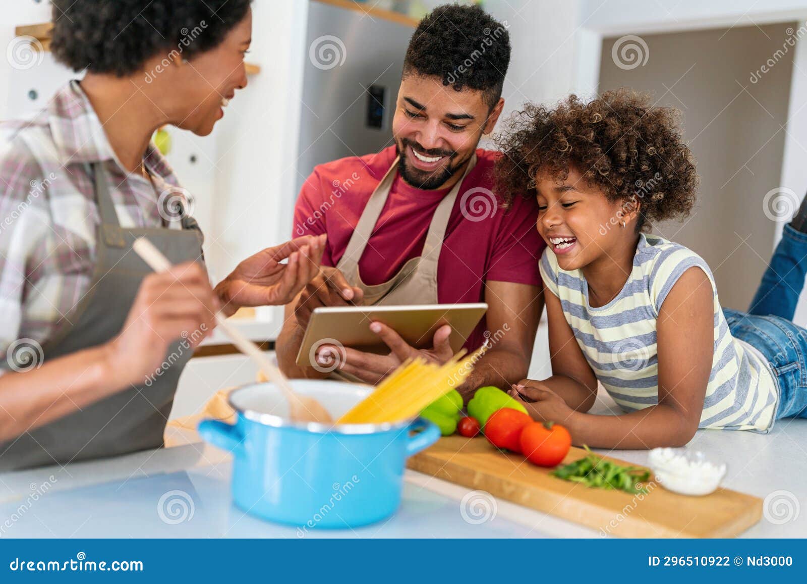 Happy Black Family in the Kitchen Having Fun and Cooking Together