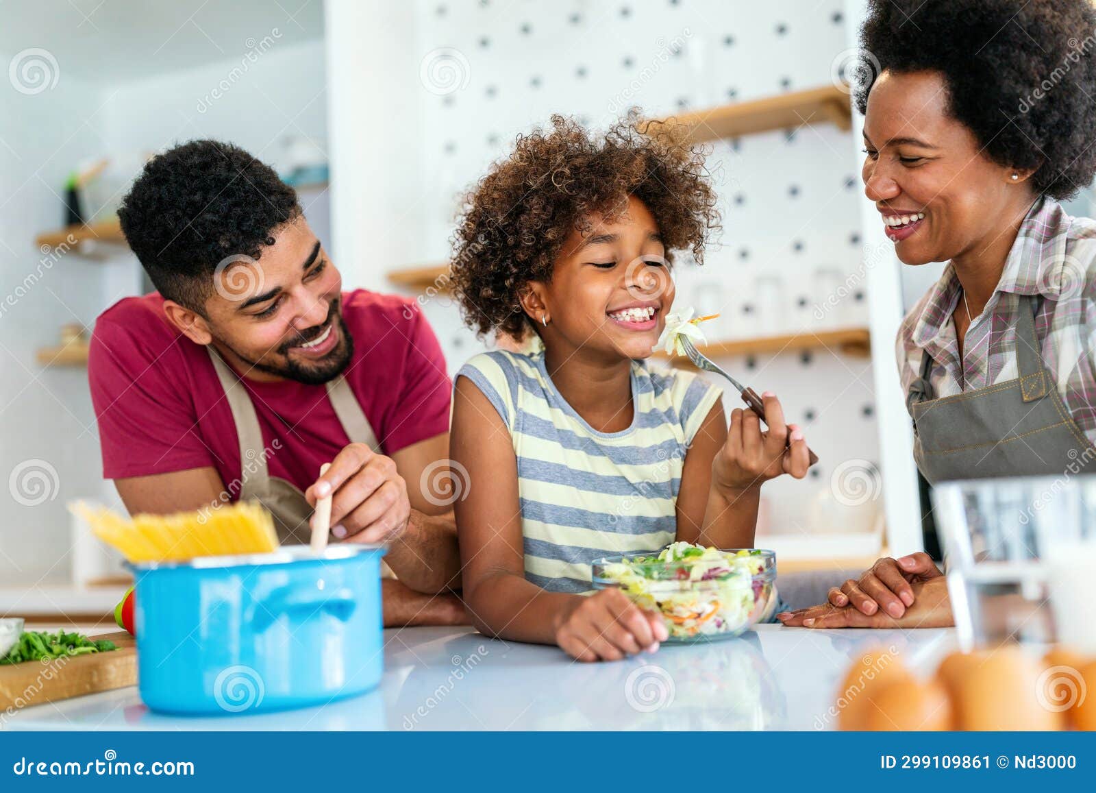 Happy Black Family in the Kitchen Having Fun and Cooking Together