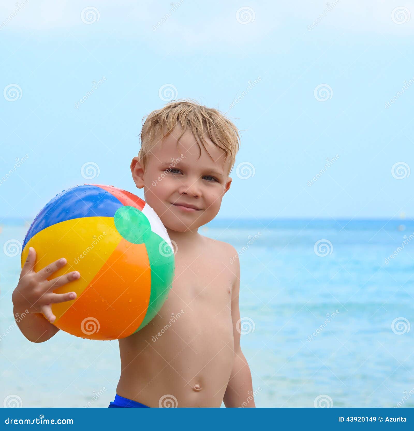 Happy boy with beach ball stock image. Image of holding 43920149