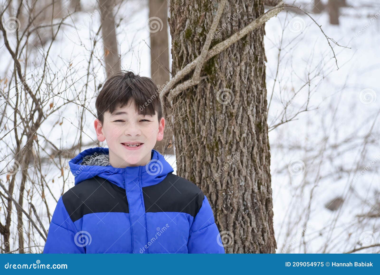 happy boy in forest in winter