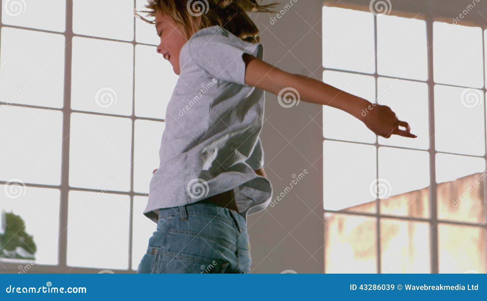 Happy Boy Jumping Up And Down In Front Of Window Stock Video