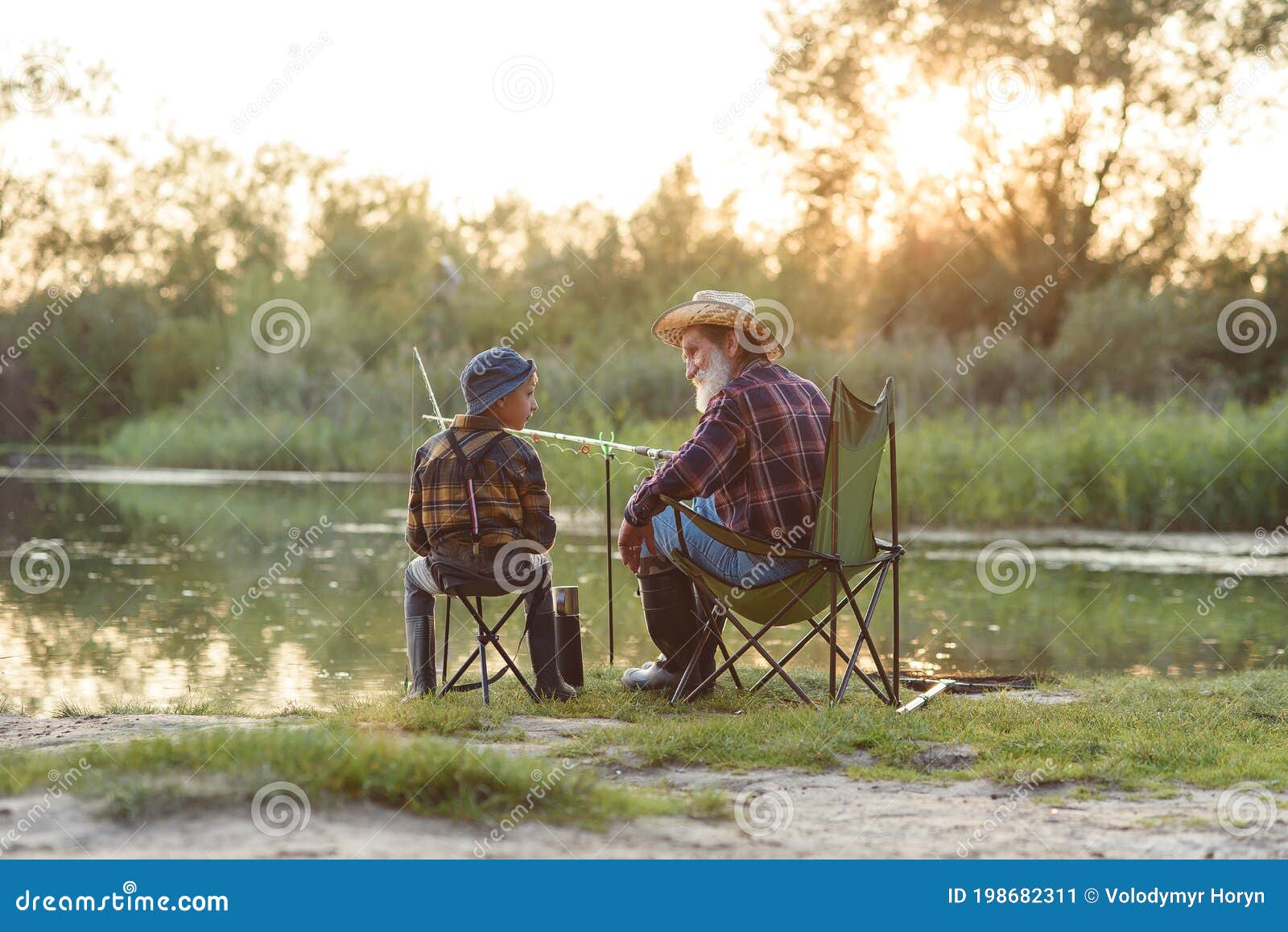 Happy Boy Sitting on Chairs Together with His Experienced Old Grey-bearded  Grandpa and Fishing with Rods on the Lake. Stock Image - Image of  childhood, bearded: 198682311