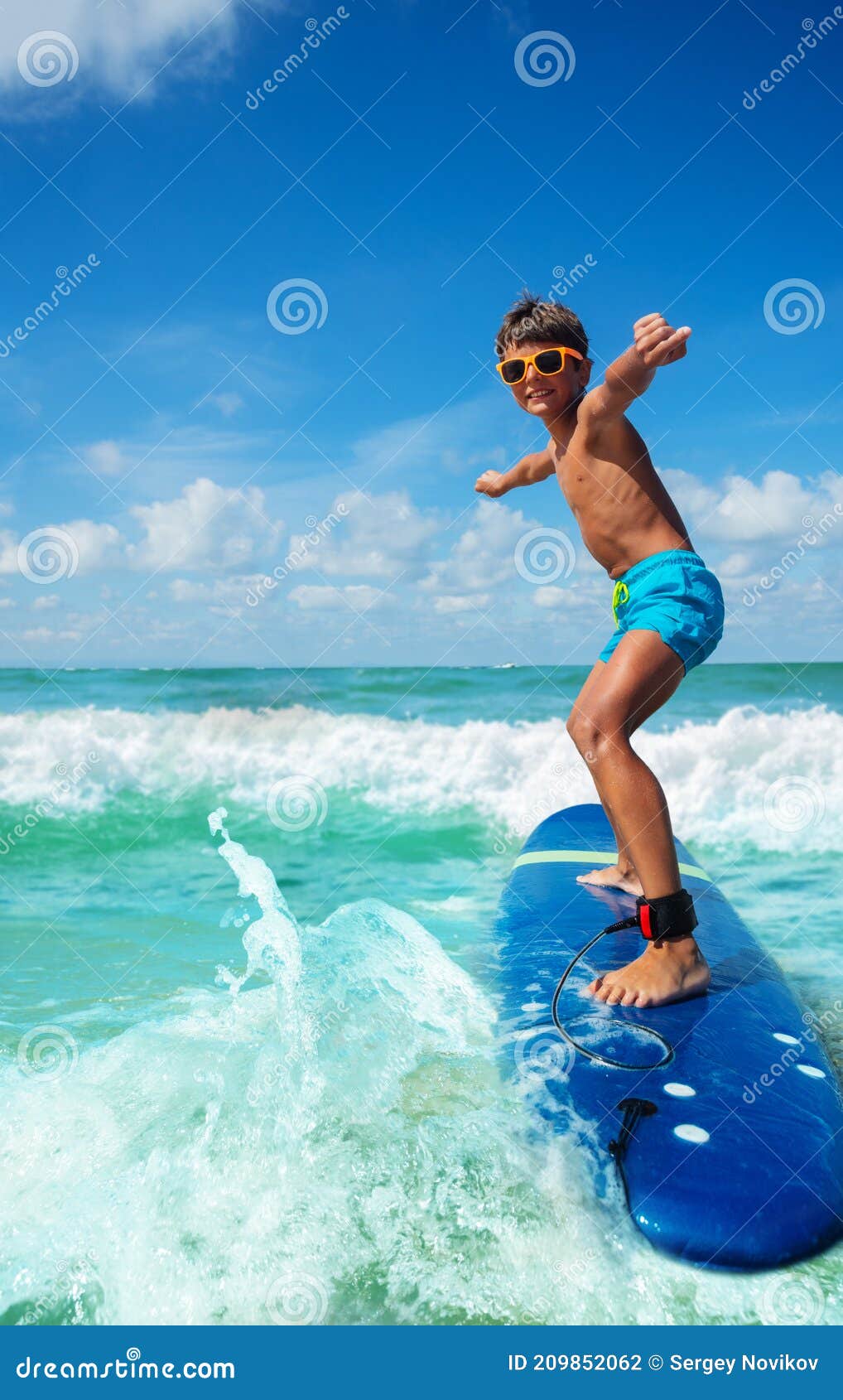 Happy Boy on the Surfboard Riding a Wave in Shades Stock Photo - Image ...