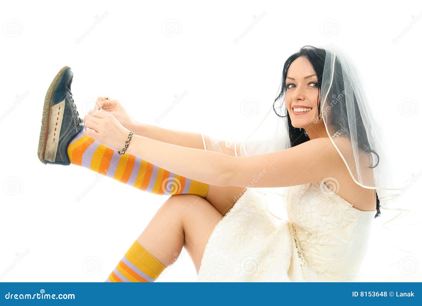 happy bride putting on sporting shoes