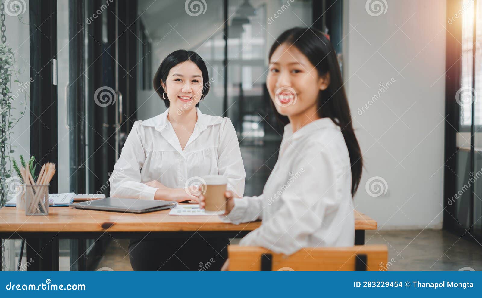 happy business woman smiling face and happiness while discussing data in the office