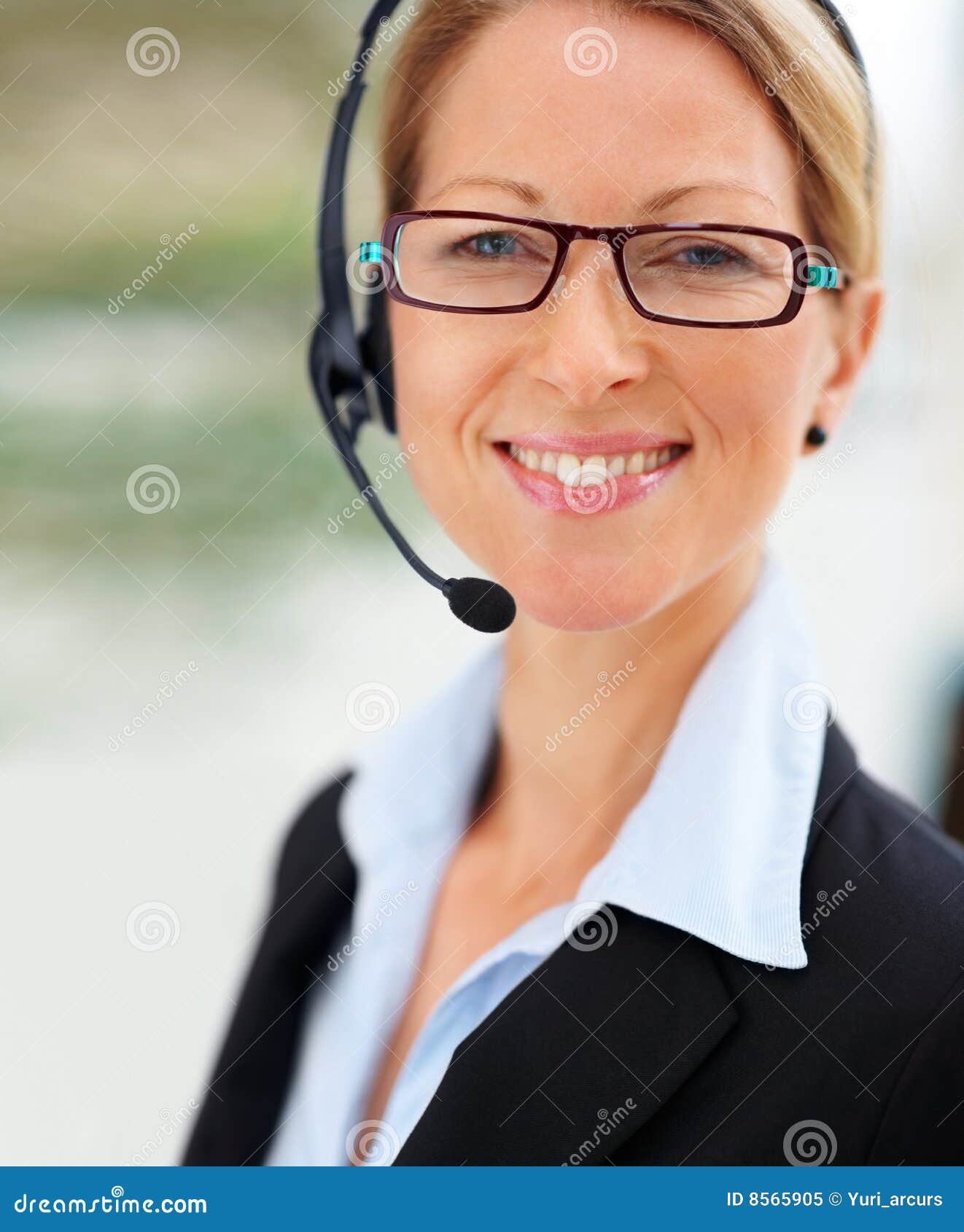 Closeup of a mature beautiful happy business woman using headset and smiling