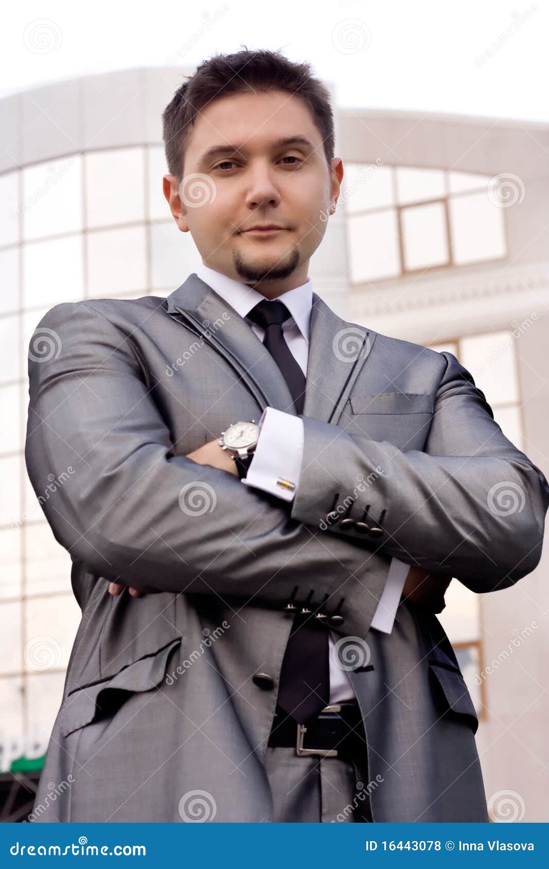 Happy businessman with his arms crossed