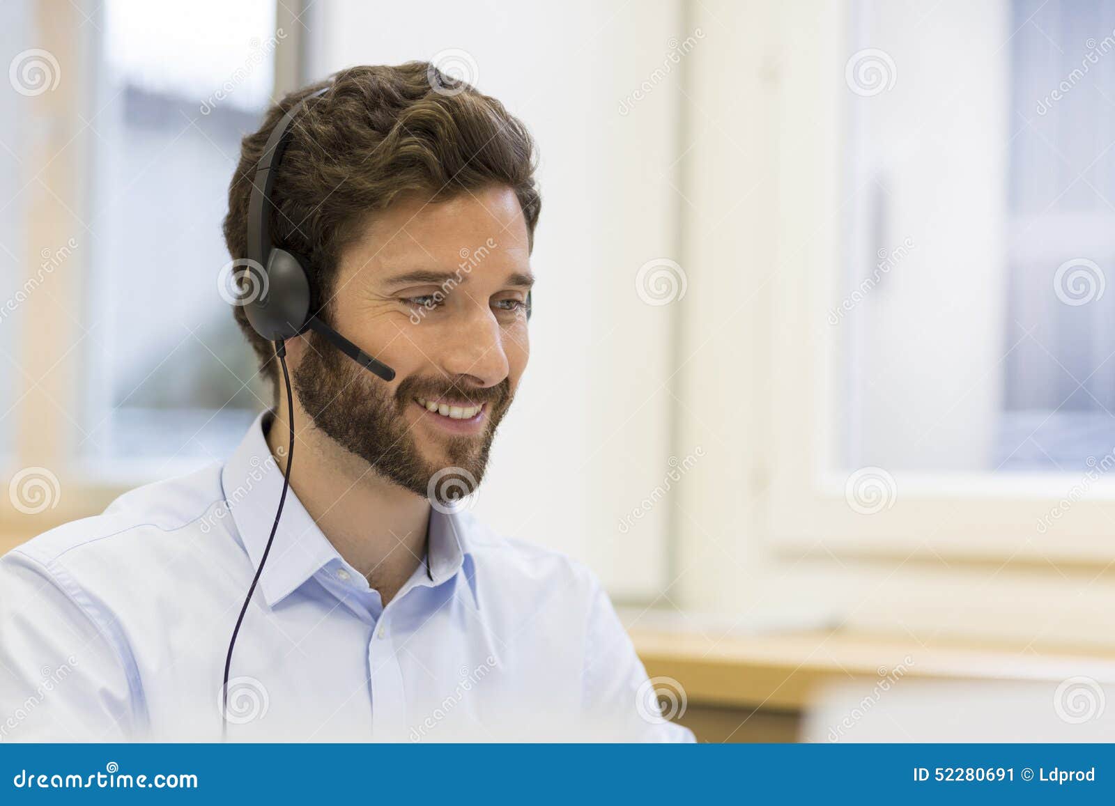 happy businessman in the office on the phone, headset, skype