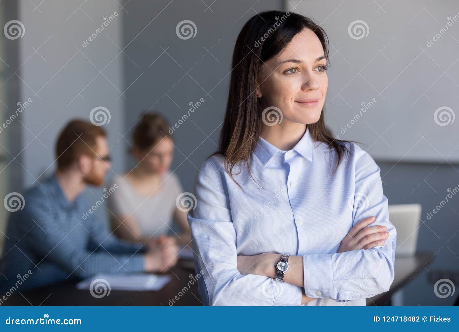 smiling businesswoman looking from window dreaming of future suc