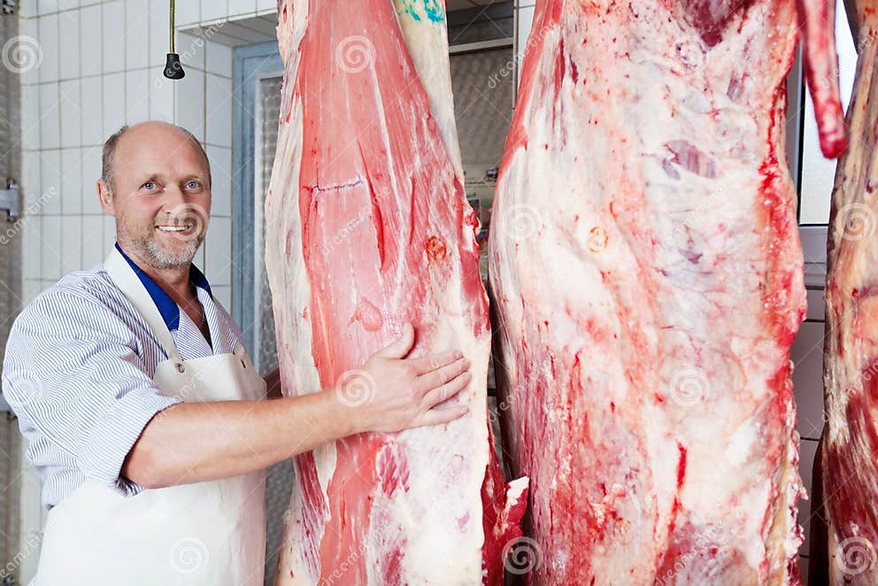 happy-butcher-close-to-cow-carcasses-middle-age-near-three-carcass-halves-butchery-31303188.jpg