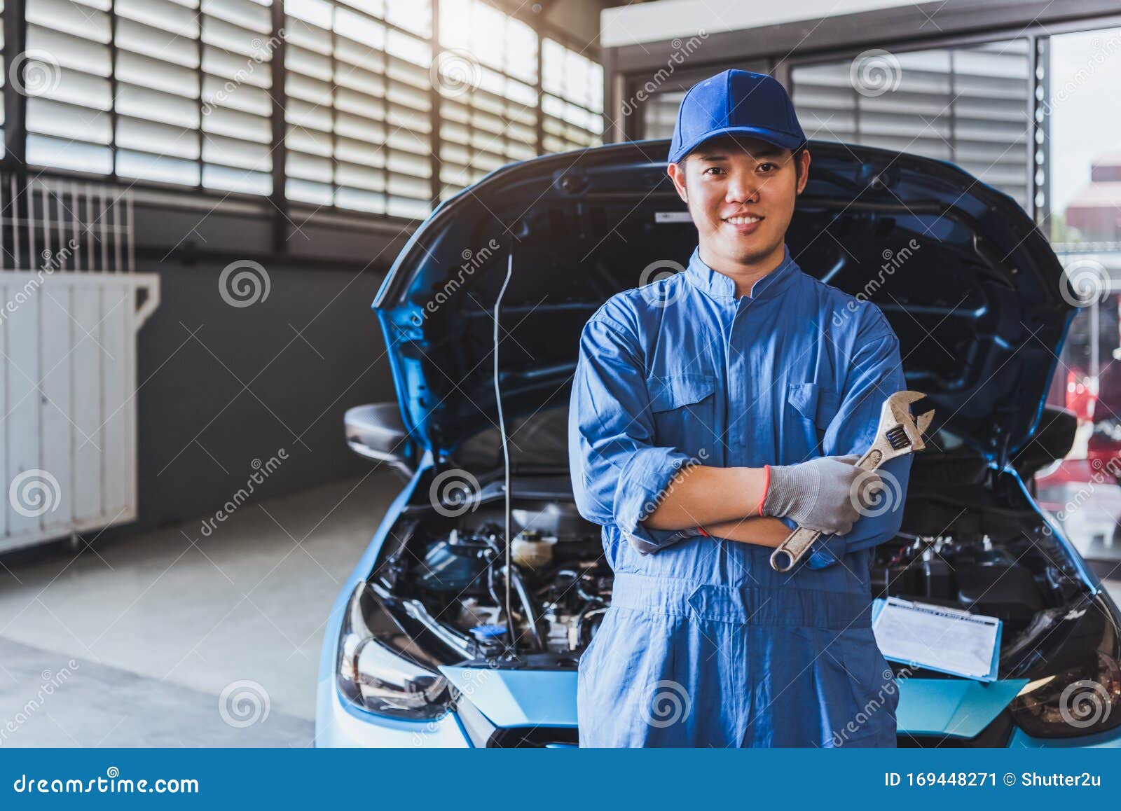 Happy Car Mechanic Inspection Technician Holding Wrench And Smiling To