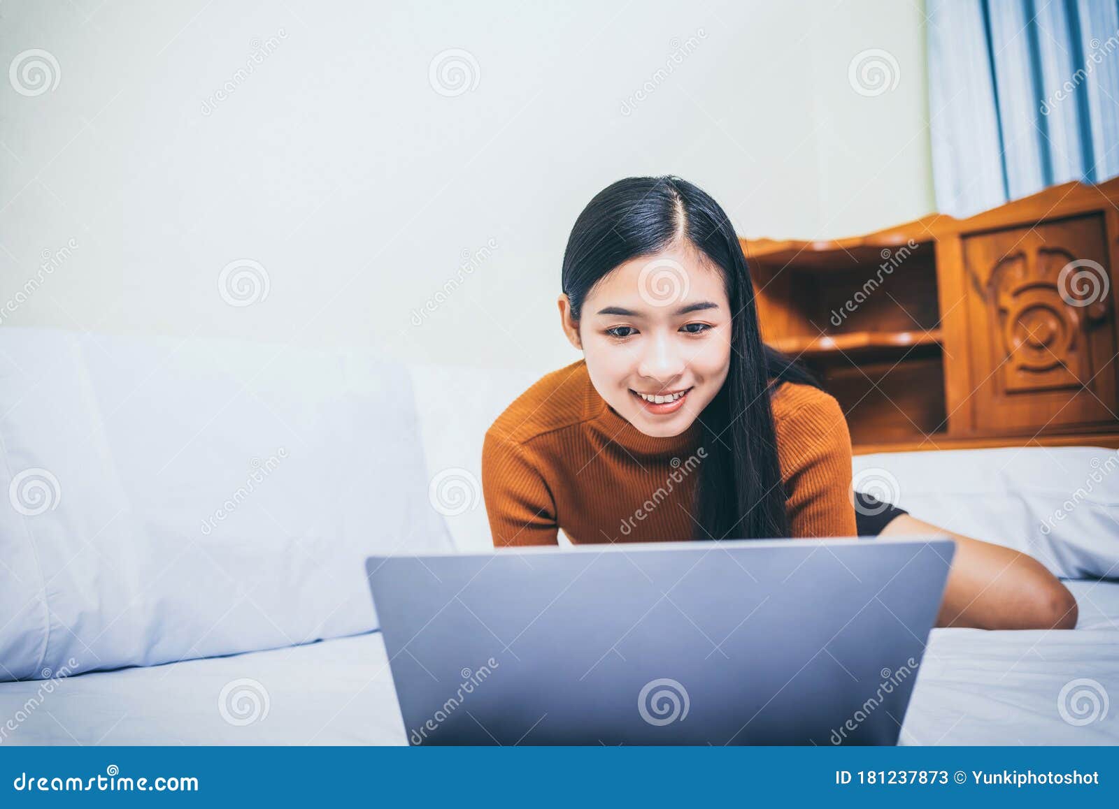happy casual asian woman working in bed with laptop in the house, wfh work from home concept