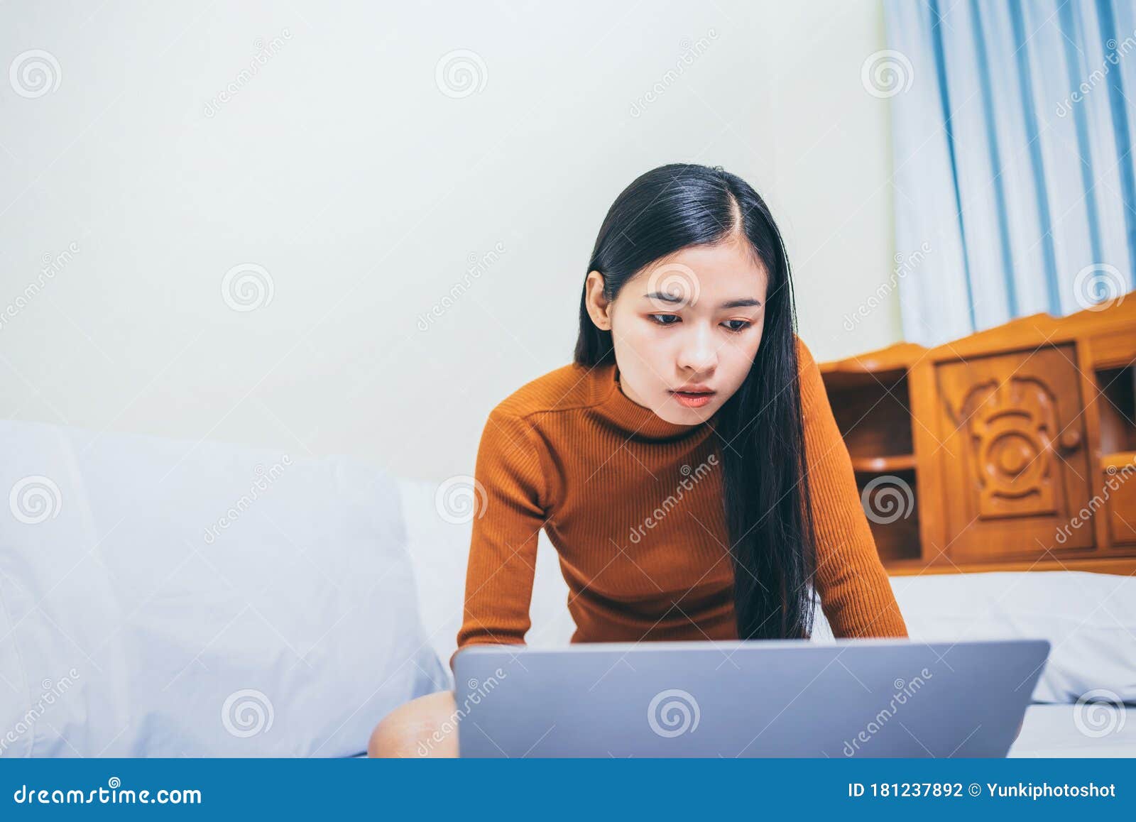 happy casual asian woman working in bed with laptop in the house, wfh work from home concept