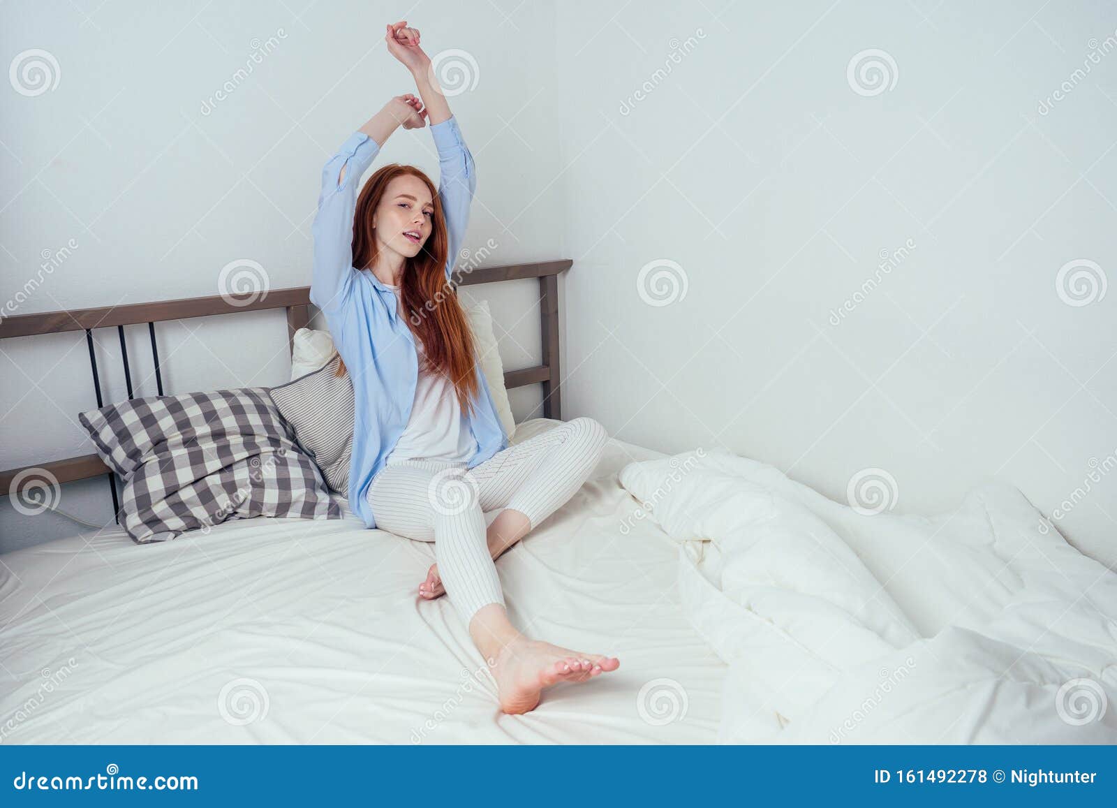 happy caucasian beautiful redhaired ginger freckles female awake in bedroom