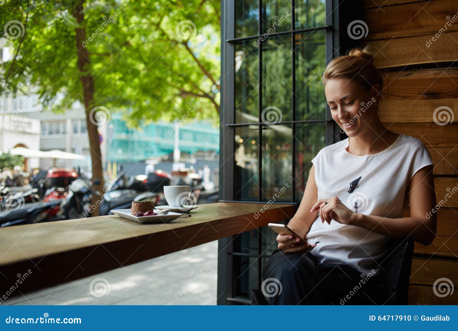 Happy Caucasian Female Watching Her Photo on Cell Telephone while ...